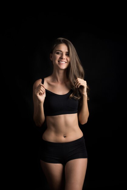 Beautiful woman with healthy body on black background