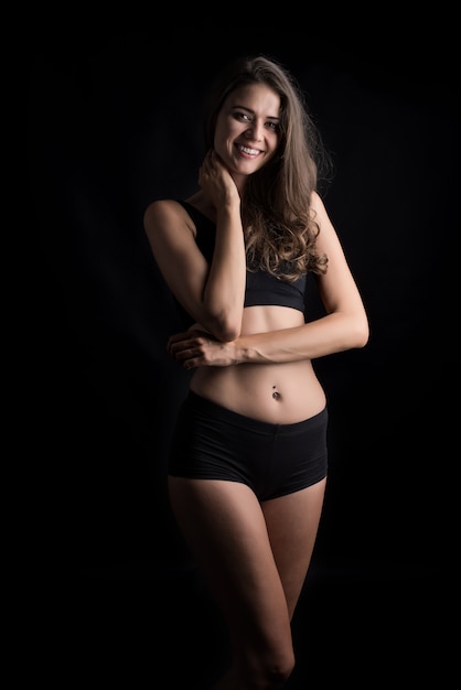 Beautiful woman with healthy body on black background