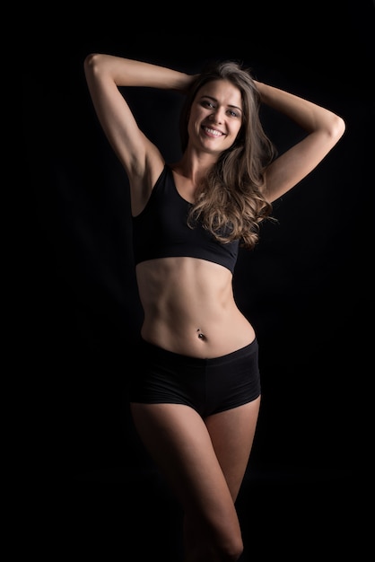 Beautiful woman with healthy body on black background