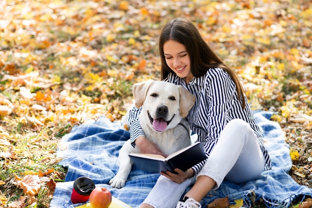 Free photo beautiful woman with her dog in the park