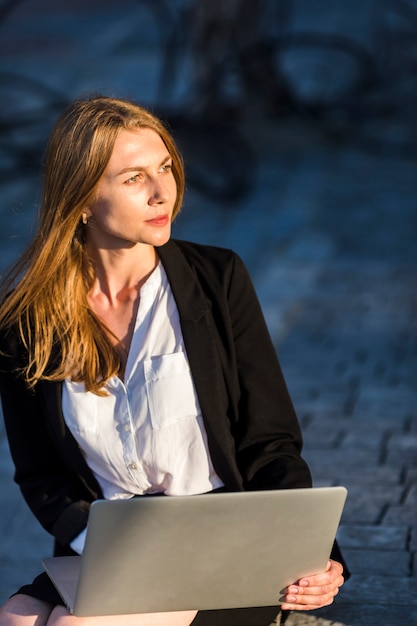 Beautiful woman with a laptop outdoors