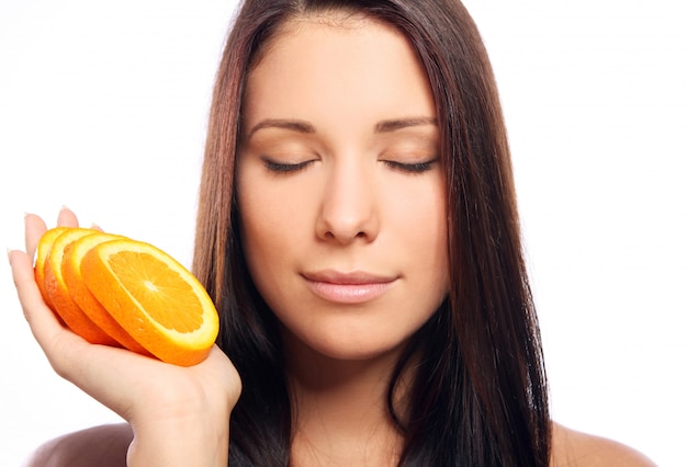 Beautiful woman with orange in hands