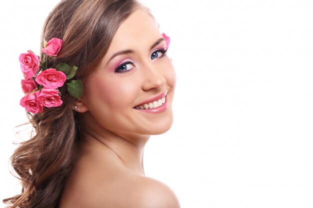 Beautiful woman with roses in hair