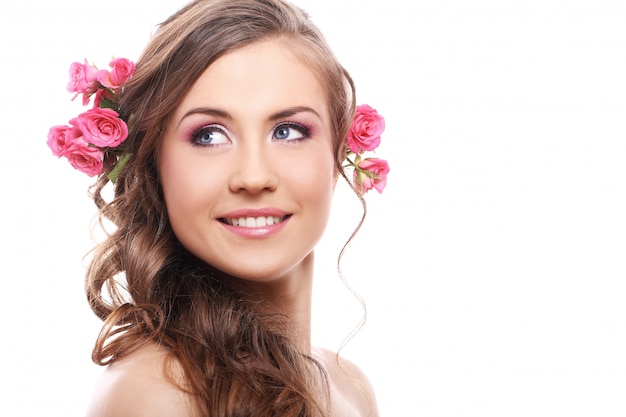 Beautiful woman with roses in hair