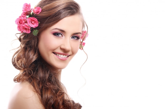 Free photo beautiful woman with roses in hair