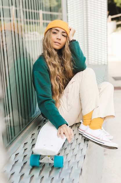 Free photo beautiful woman with skateboard