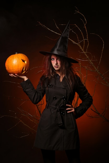 Beautiful woman witha pumpkin in the hands