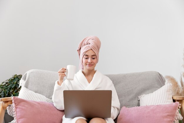 Beautiful woman working after taking a bath