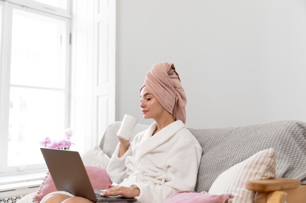 Beautiful woman working after taking a bath