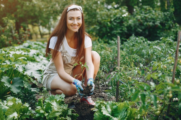 Free photo beautiful woman works in a garden