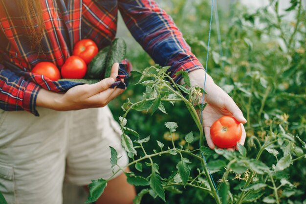 Beautiful woman works in a garden 