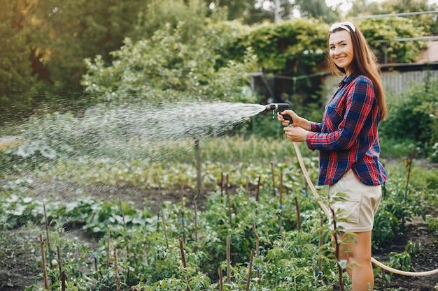 Beautiful woman works in a garden 