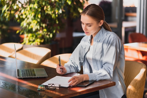 Beautiful woman writing on a clipboard