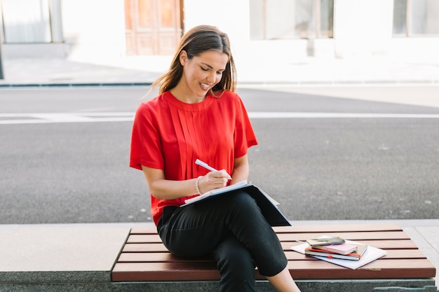 Beautiful woman writing note in diary