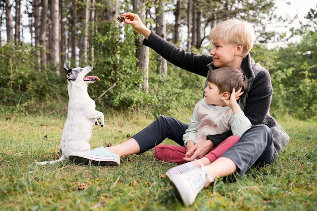 Free Photo beautiful woman and young boy playing with dog