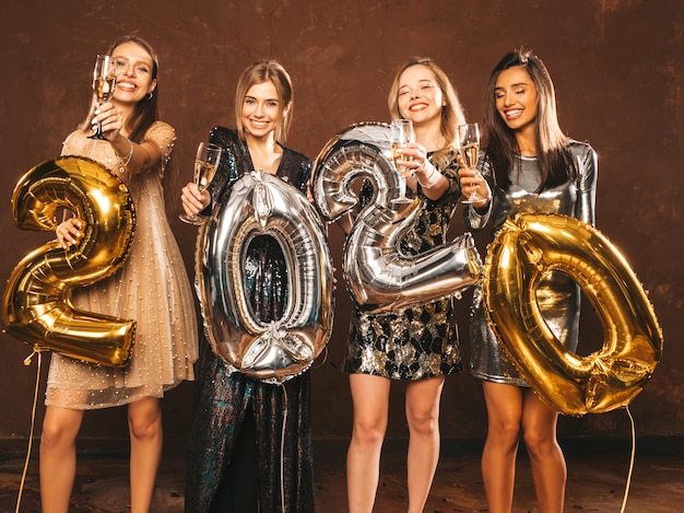 Beautiful Women Celebrating New Year.Happy Gorgeous Girls In Stylish Sexy Party Dresses