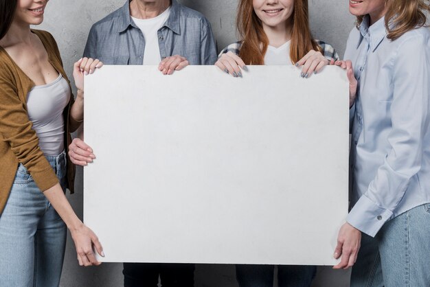 Beautiful women holding a sign together