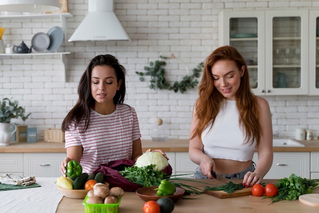 Beautiful women preparing together their dinner