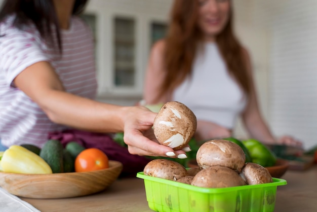 Beautiful women preparing together their dinner