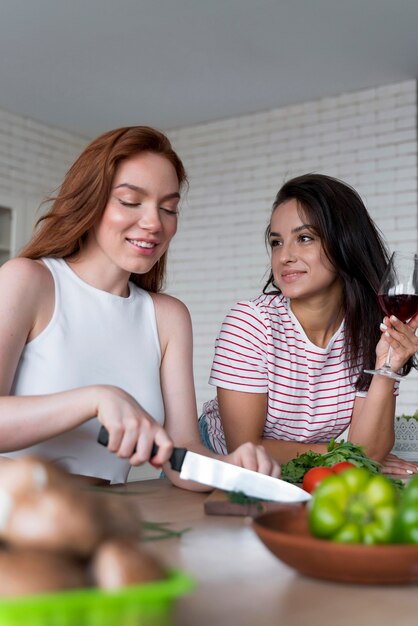 Beautiful women preparing together their dinner