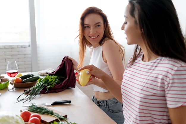 Beautiful women preparing together their dinner