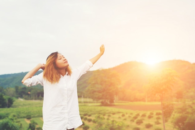 Beautiful women standing raising arm after waking, enjoy with fr