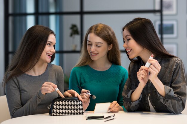 Beautiful women trying out make-up accessories