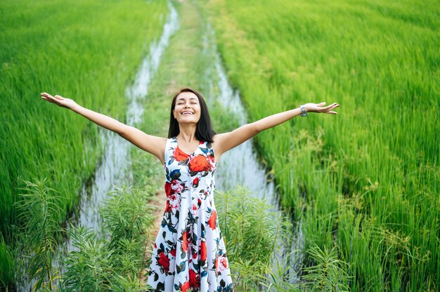 Beautiful women walk happily on the meadow