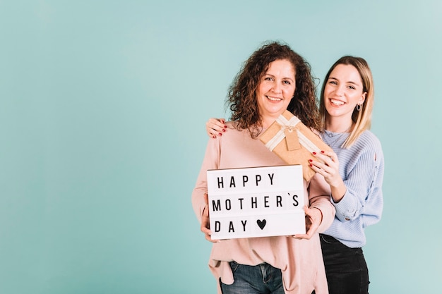 Free photo beautiful women with gift and mother's day greeting