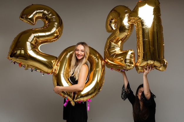 Beautiful women with New Year balloons 2021.