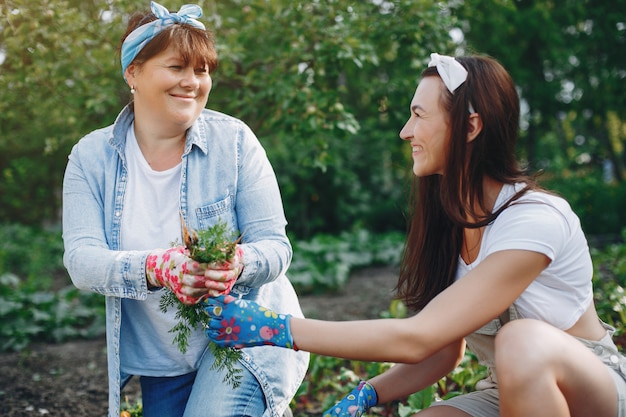 Free photo beautiful women works in a garden