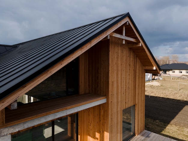 Beautiful wooden house with dark roof