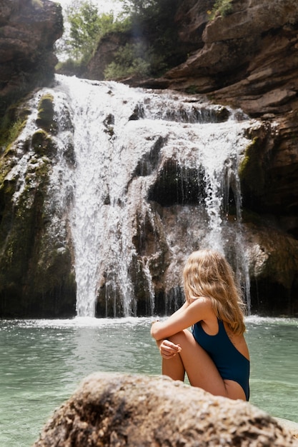 Beautiful young adult by the waterfall