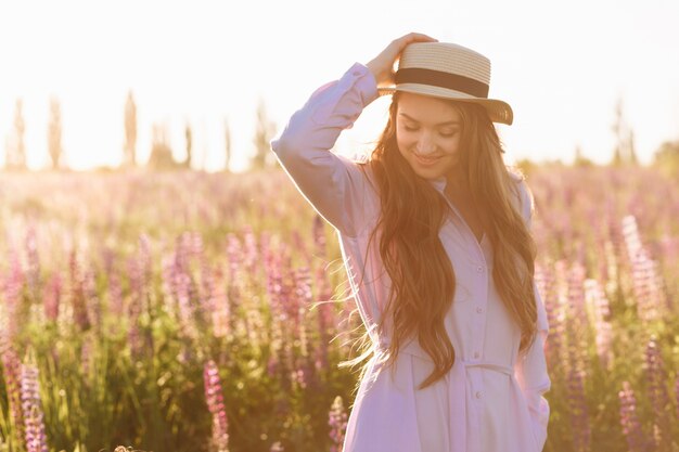 a beautiful young brunette woman. attractive sexy girl in a field with flowers