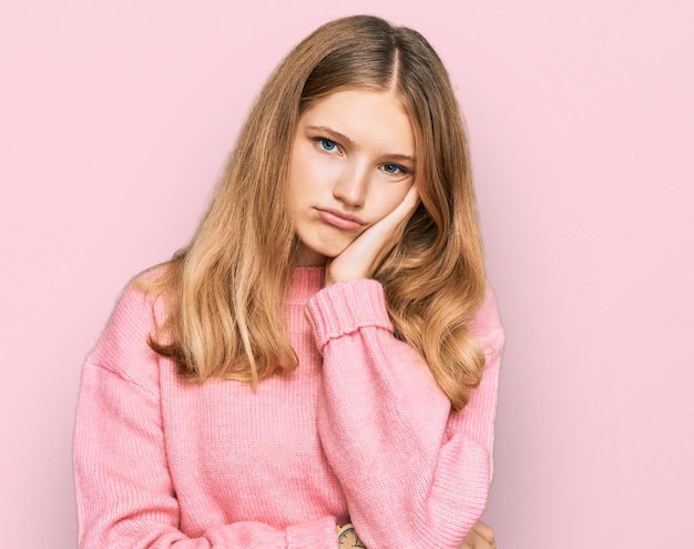 Beautiful young caucasian girl wearing casual winter sweater thinking looking tired and bored with depression problems with crossed arms.