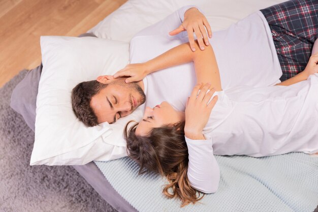 Beautiful young couple in bedroom