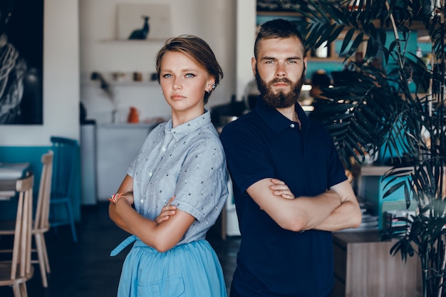 Beautiful young couple posing in cafe, love and tenderness