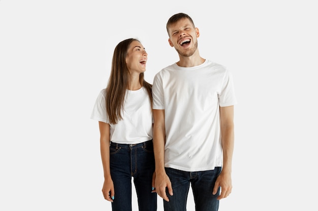 Free Photo beautiful young couple's portrait isolated. facial expression, human emotions. man and woman standing, looking at each other and smiling.