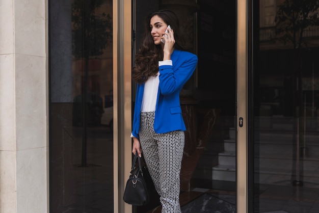 Beautiful young employee talking on the phone