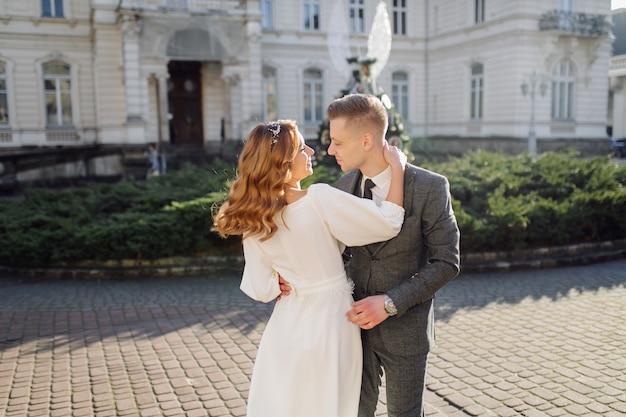 Beautiful young fashion stylish couple walking on the street in city