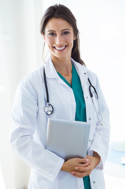 Beautiful young female doctor looking at camera in the office.