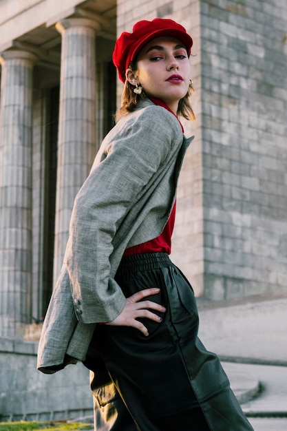 Free photo beautiful young female model posing in front of building