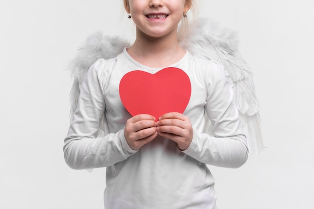 Free Photo beautiful young girl holding a heart