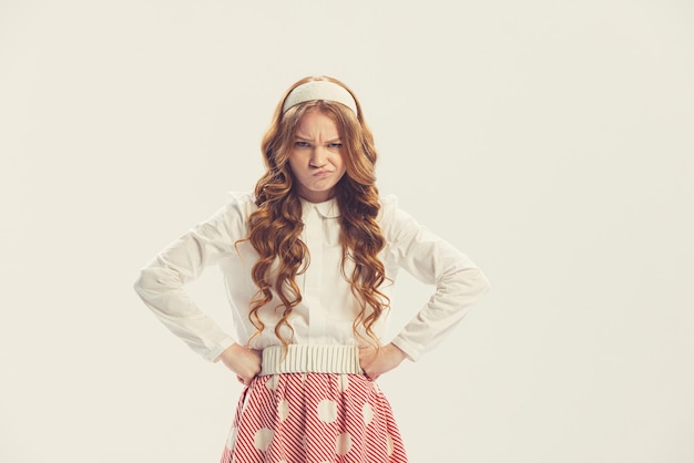 Free photo beautiful young girl making funny faces posing isolated over white studio background retro style