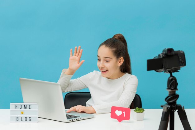 Beautiful young girl recording at home