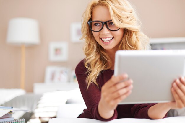 Free Photo beautiful young girl using digital tablet at home