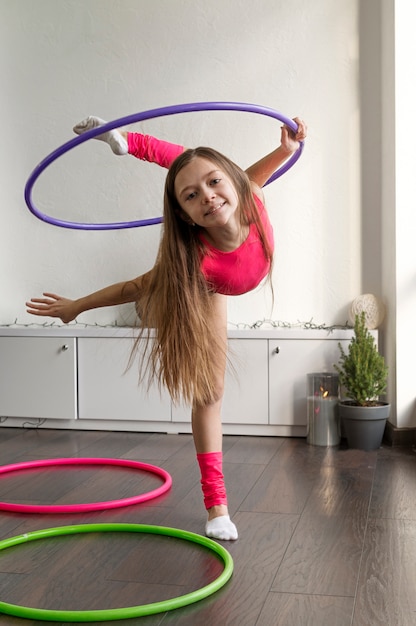 Beautiful young girl using hula hop