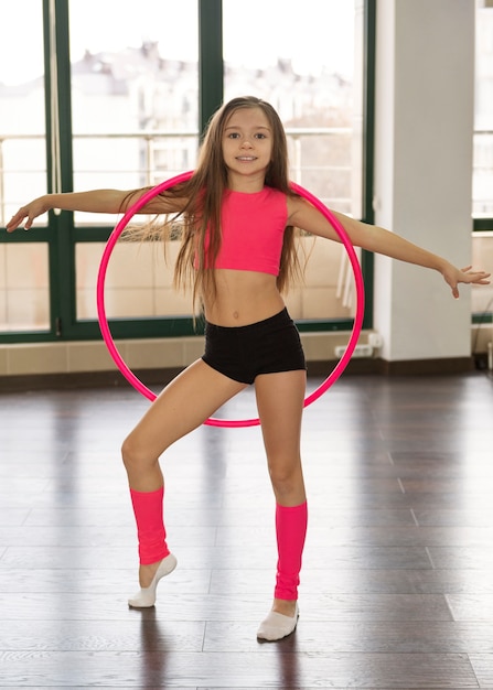 Beautiful young girl using hula hop