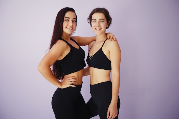 Free photo beautiful and young girls in a gym