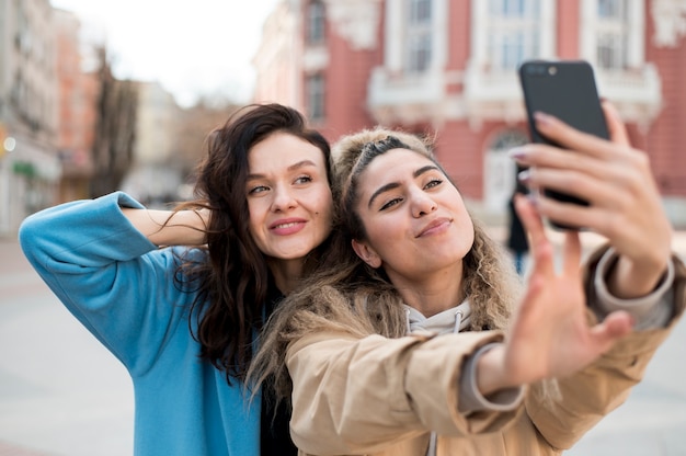 Free Photo beautiful young girls taking a selfie together